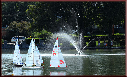 Model yachts being sprayed in a fountain